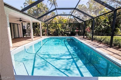 Huge wrap-around pool paver lanai under truss