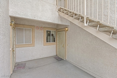 Property entrance featuring stucco siding and a pa