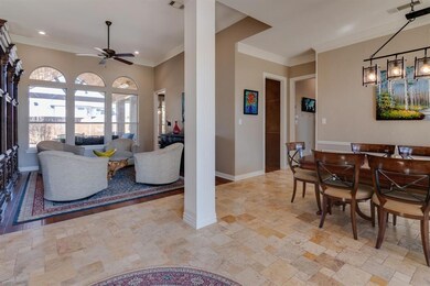 Beautiful Travertine flooring in the entry sets the stage to this exceptional home.
