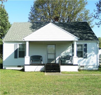 Country farm house welcomes you with a rocking chair front porch.