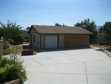 LONG CONCRETE DRIVEWAY LEADS TO SECOND GARAGE/WORK