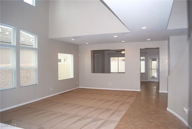Living room/dining room area with vaulted ceiling