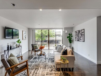 Living room featuring dark wood-style floors and 