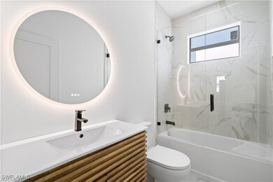 Full bathroom featuring vanity, toilet, and combin
