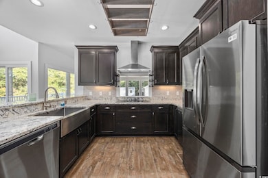 Kitchen with decorative backsplash, wall chimney r