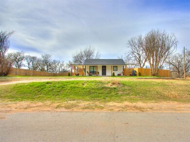 Ranch-style house with curved driveway, a porch, and fence