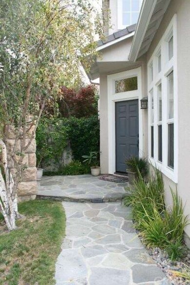 Gorgeous stone hardscaping leads you to the front 