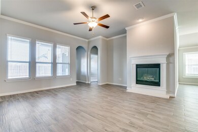 Unfurnished living room with ceiling fan, crown molding, and light hardwood / wood-style flooring