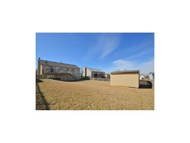 Large level fenced yard with storage shed.