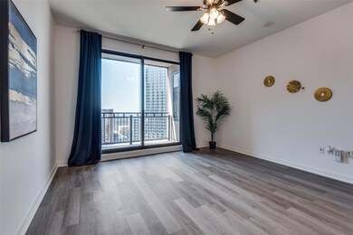 Unfurnished room with ceiling fan and wood-type fl