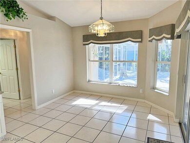 Unfurnished dining area featuring a wealth of natural light, a notable chandelier, and light tile patterned flooring