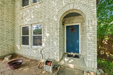 Entrance to property featuring brick siding