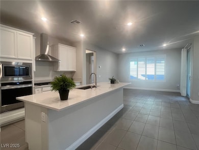 Kitchen with stainless steel appliances, a sink, w