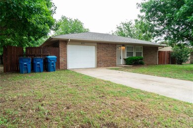 Ranch-style house with an attached garage, brick siding, and driveway