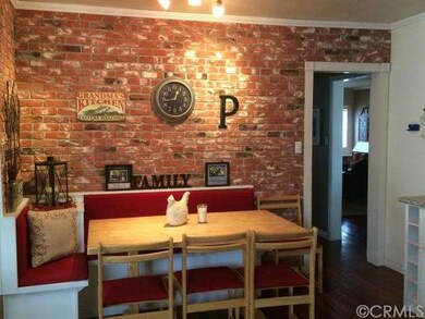 Dinette area in family room with exposed brick wal