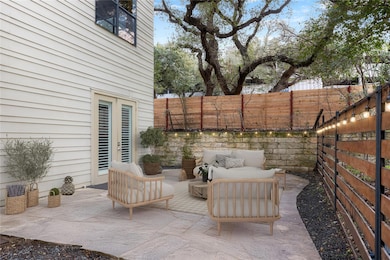 Fenced backyard with a patio, outdoor lounge area, and french doors