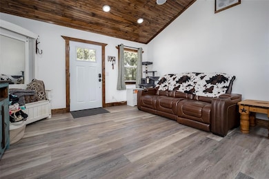 Foyer with wooden ceiling, wood finished floors, high vaulted ceiling, and recessed lighting