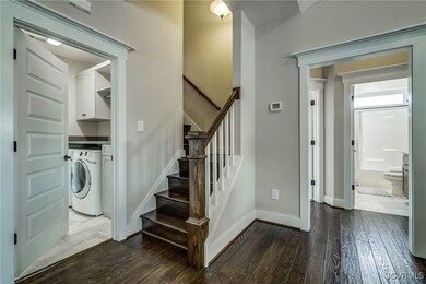 Staircase featuring washer / clothes dryer, hardwo