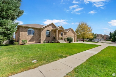 View of front of home with brick siding, a front yard