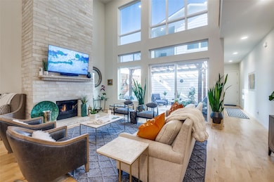 Living area with wood finished floors, a brick fir
