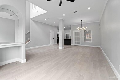 Unfurnished living room featuring crown molding, recessed lighting, a chandelier, stairway, and wood tiled floors