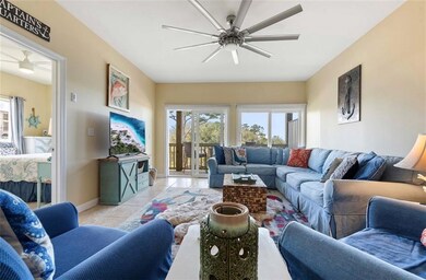 Living room with ceiling fan, plenty of natural light, and light tile patterned floors