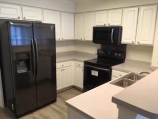 New black stainless steel, fingerprint resistant appliances.   Water proof flooring extends into kitchen.  
