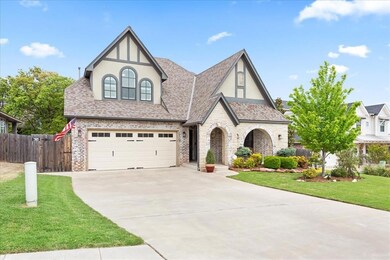 Tudor house featuring a garage and a front yard