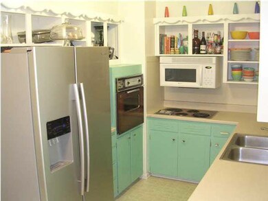 Kitchen w/ Built-In Microwave + Refrigerator Remai