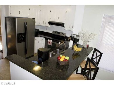 Kitchen - Sleek kitchen offers raised bar seating 