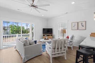 Living area featuring ornamental molding, ceiling fan, light wood-style flooring, recessed lighting, and baseboards