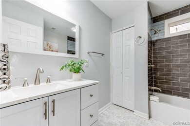 Bathroom with light tile flooring, tiled shower /