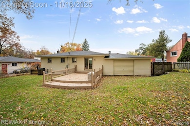 Back of property featuring a wooden deck, a fenced backyard, and a gate