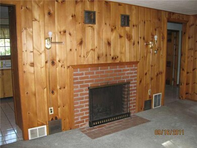 Living Room. Brick fireplace in...
