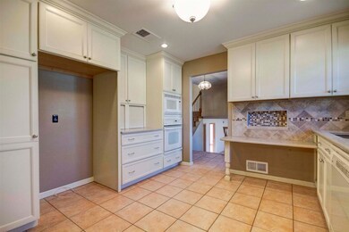 Quartz countertops, new backsplash in this high-en