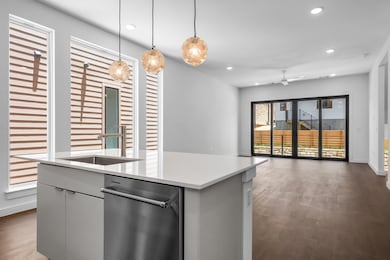 Kitchen featuring dishwasher, open floor plan, an