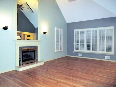 This freshly painted, large living room boasts har