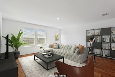 Living room with hardwood / wood-style flooring