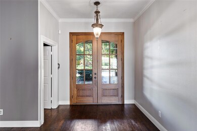 Foyer featuring french doors, ornamental molding, 