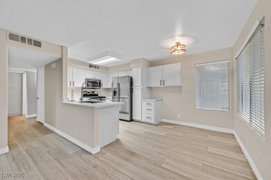 Kitchen featuring light countertops, appliances wi