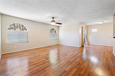 Spare room with ceiling fan, a textured ceiling, a