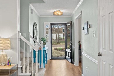 Foyer entrance with stairway, wood finished floors