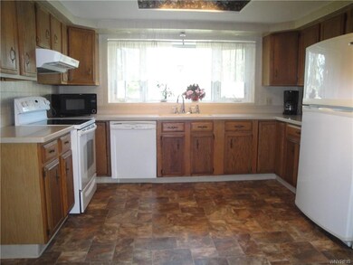 Open Kitchen with Corian Counters and Large Bay Wi