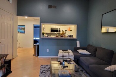 Living room with a towering ceiling and light woo