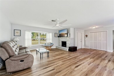Living room with light hardwood / wood-style floor