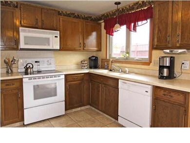 Open Kitchen With Laminate Tile Flooring