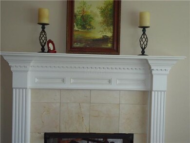 Very pretty fireplace with intricate woodwork on m