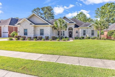 View of front of home with a front yard, brick siding, and a shingled roof