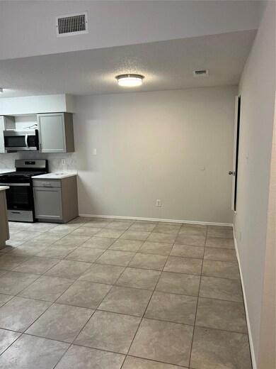 Kitchen with light tile patterned flooring, visib