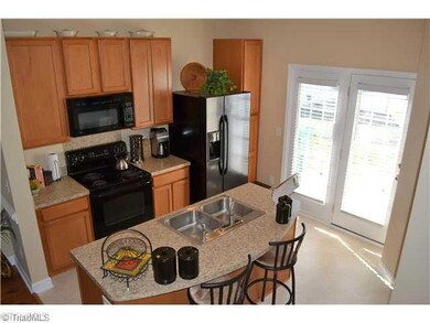 Kitchen. This is the perfect kitchen!  Plenty of cabinet space, an island with seating, and stylish black appliances!
